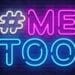 #MeToo in neon on dark brick wall