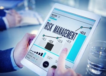 man using risk management software on tablet
