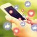 woman holding smartphone with many "like" and "heart" reactions
