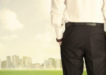 view of businessman from the back looking at city skyline