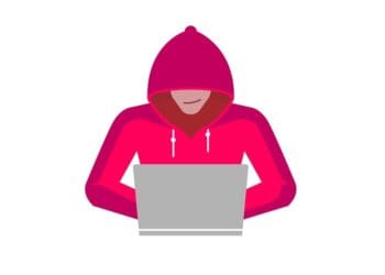 hacker in red hoodie sitting at laptop