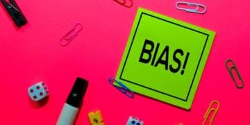 "bias" on green post-it note on pink background