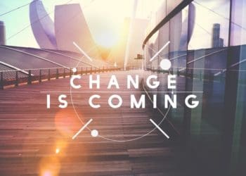 change is coming text on city background at sunset