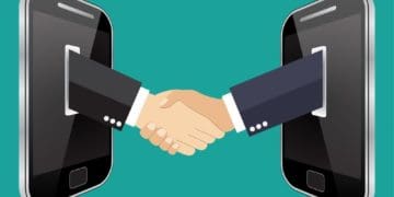 illustration of businessmen shaking hands through smartphone screens