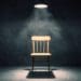 illuminated wooden chair in dark concrete room