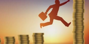 businessman jumping between increasingly taller stacks of coins