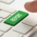 finger over green report button on white keyboard
