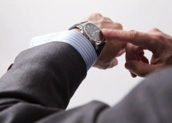 busy executive checking the time on his watch