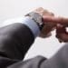 busy executive checking the time on his watch