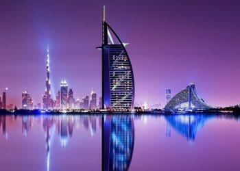 reflection of dubai skyline in the bay at dusk