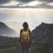 woman in yellow backpack looking out over landscape