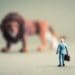 businessman facing giant lion