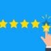hand selecting five stars on blue background
