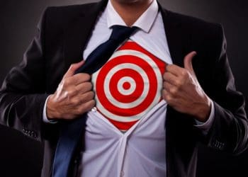 man pulling back button down shirt to reveal target underneath