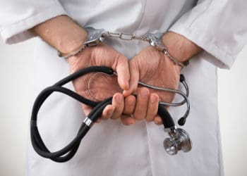 physician in handcuffs
