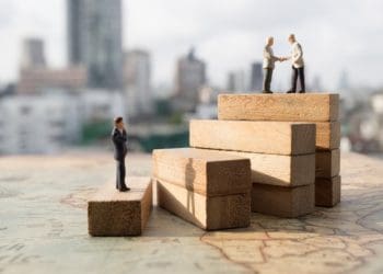 miniature people on wooden steps, concept of succession planning