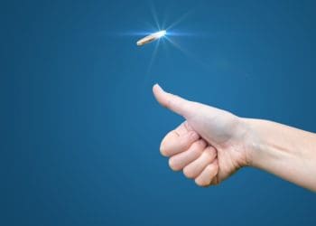 hand flipping a coin