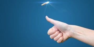 hand flipping a coin