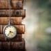 stack of old leather bound books with antique pocketwatch