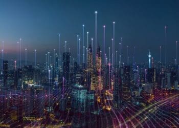 city skyline at dusk with points of light signaling digital footprint