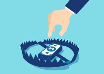 man reaching for stack of cash in bear trap