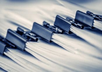 closeup of reports bound with binder clips