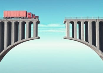 semi truck on one side of broken bridge