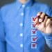 man in blue shirt checking boxes on screen