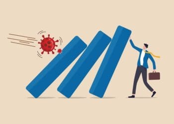 illustration of covid virus toppling dominos held up by businessman