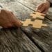 businessmen connecting large puzzle pieces