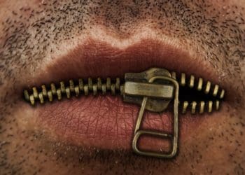 closeup of man's mouth with metal zipper keeping lips closed