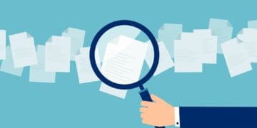 illustration of hand holding magnifying glass to review documents