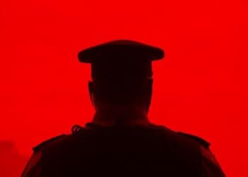 silhouette of police officer on red background