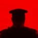 silhouette of police officer on red background
