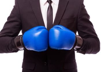 man in suit with blue boxing gloves