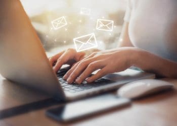 woman at laptop writing emails