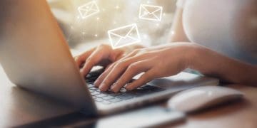 woman at laptop writing emails