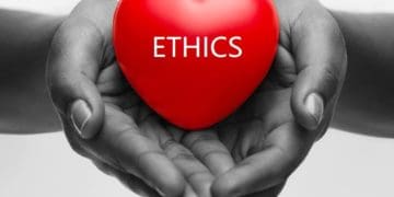 black and white image of hands holding red heart reading "ethics"