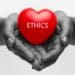 black and white image of hands holding red heart reading "ethics"