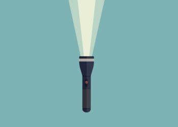 shining flashlight on green background
