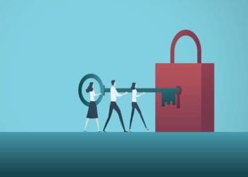 team holding giant key together, inserting giant lock