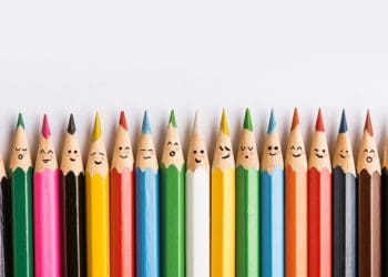 line of multicolored pencils with faces