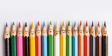 line of multicolored pencils with faces
