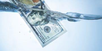 $100 bill floating in water