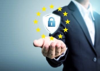 Businessman hand holding sign general data protection regulation (GDPR) and shield with key icon