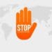 orange hand reading "stop corruption" on global map in grayscale