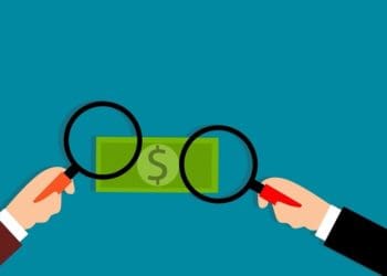 illustration of two hands with magnifying glasses held over cash