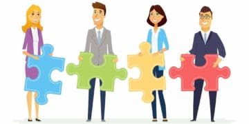 four team members holding blue, green, yellow and red puzzle pieces