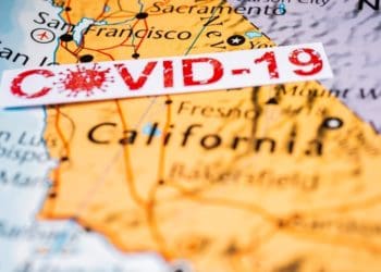 covid-19 sign over map of california