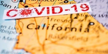 covid-19 sign over map of california